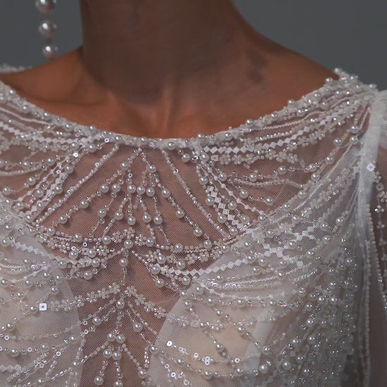 Beaded lace sheath wedding dress with illusion neckline and long sleeves – video