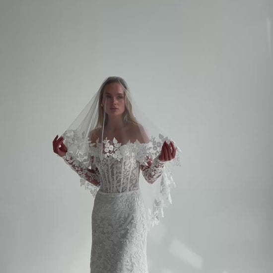 Video: bride in a lace wedding dress with a sheer lace-trimmed veil