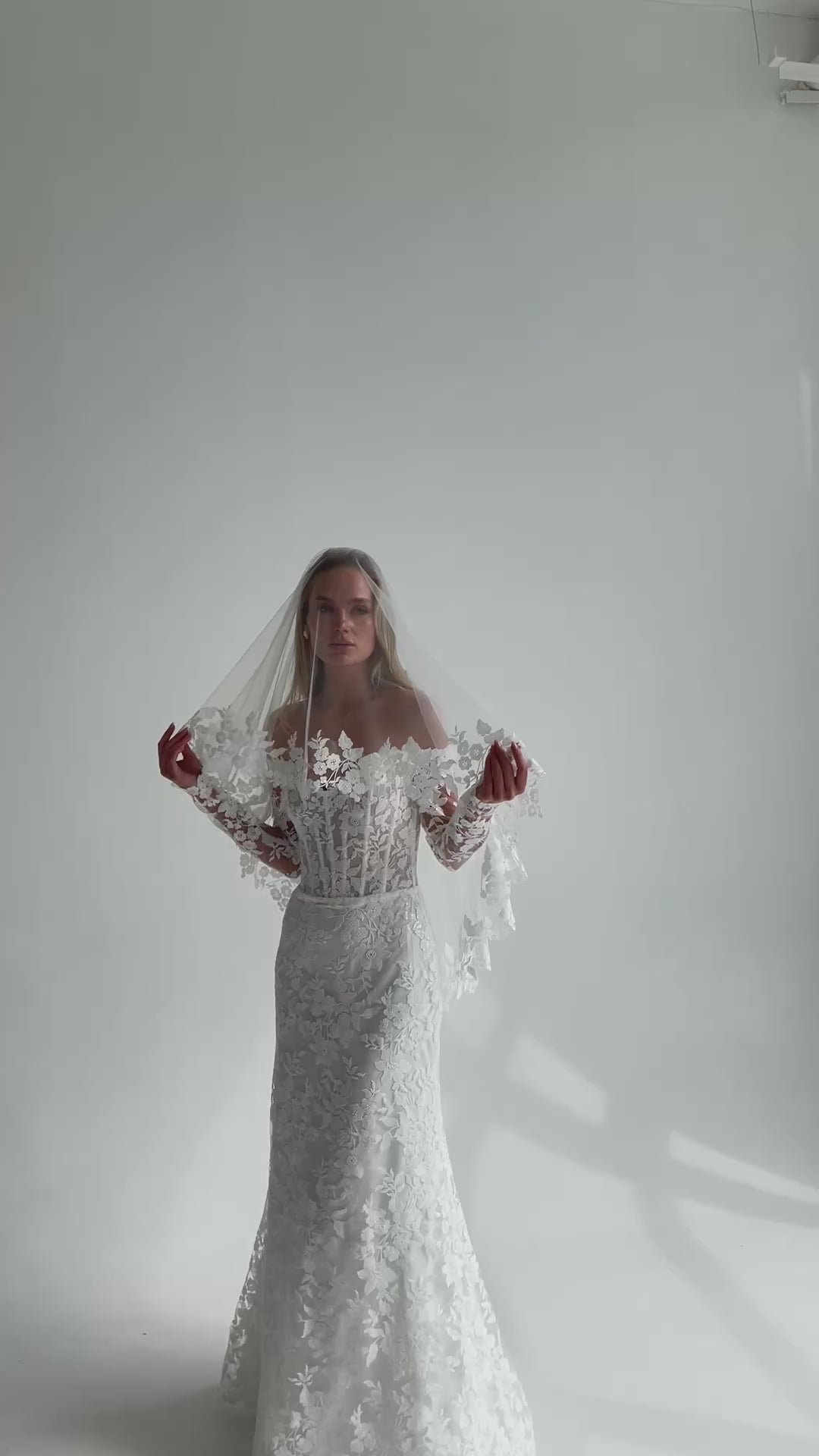 Video: bride in a lace wedding dress with a sheer lace-trimmed veil