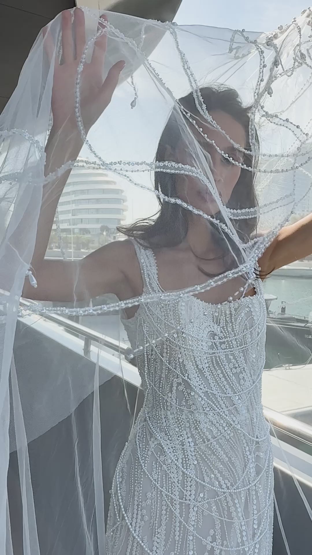 Sculpted beaded mermaid wedding gown with scoop neckline, pearl-inspired detailing, and soft tulle chapel train.