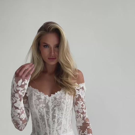 Video: close-up of a lace corset bodice with long floral lace sleeves