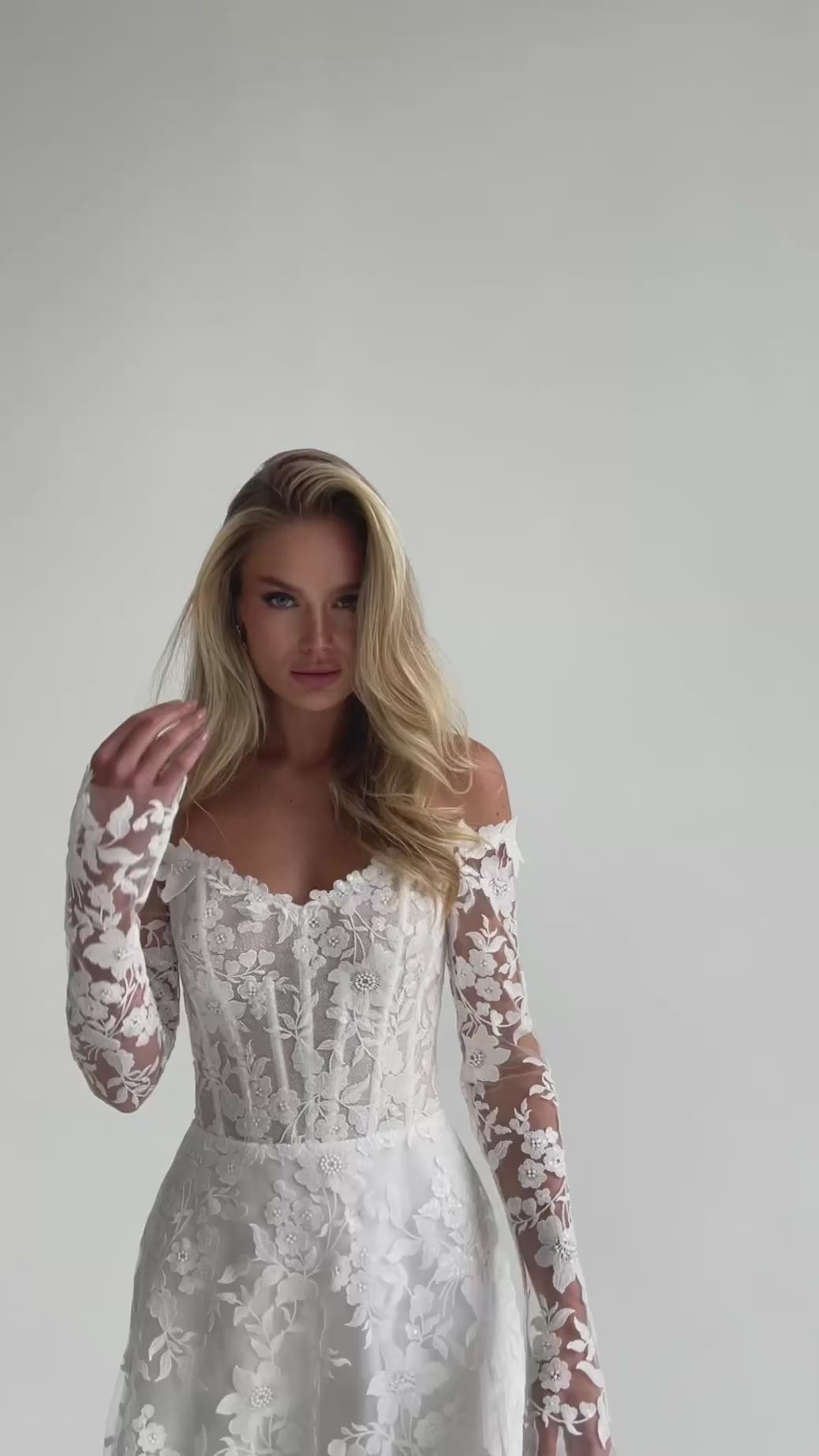 Video: close-up of a lace corset bodice with long floral lace sleeves
