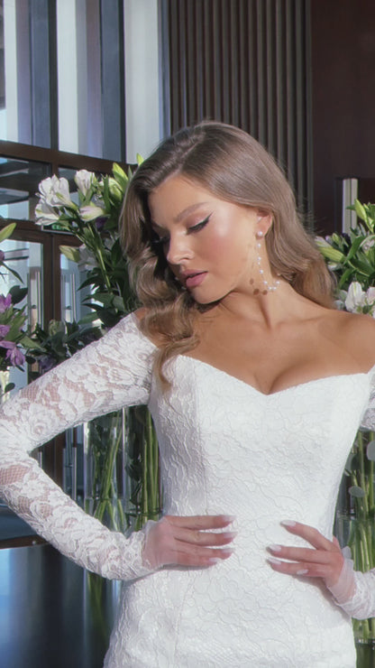 Off the shoulder lace mermaid wedding dress with long sleeves.