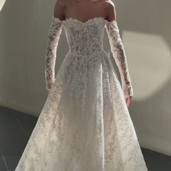 Celeste off-shoulder lace and tulle ball gown with detachable long sleeves and chapel train.