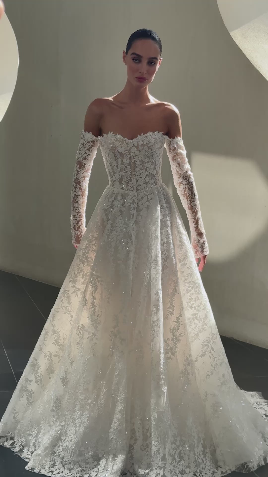 Celeste off-shoulder lace and tulle ball gown with detachable long sleeves and chapel train.
