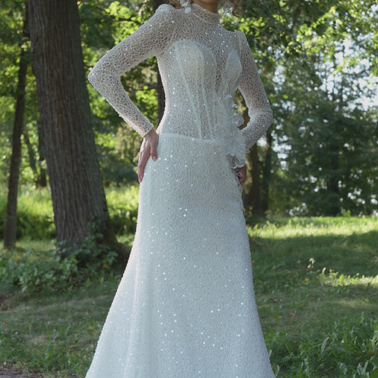 long sleeve lace mermaid wedding dress with high neckline, beaded illusion bodice and floral waist accent