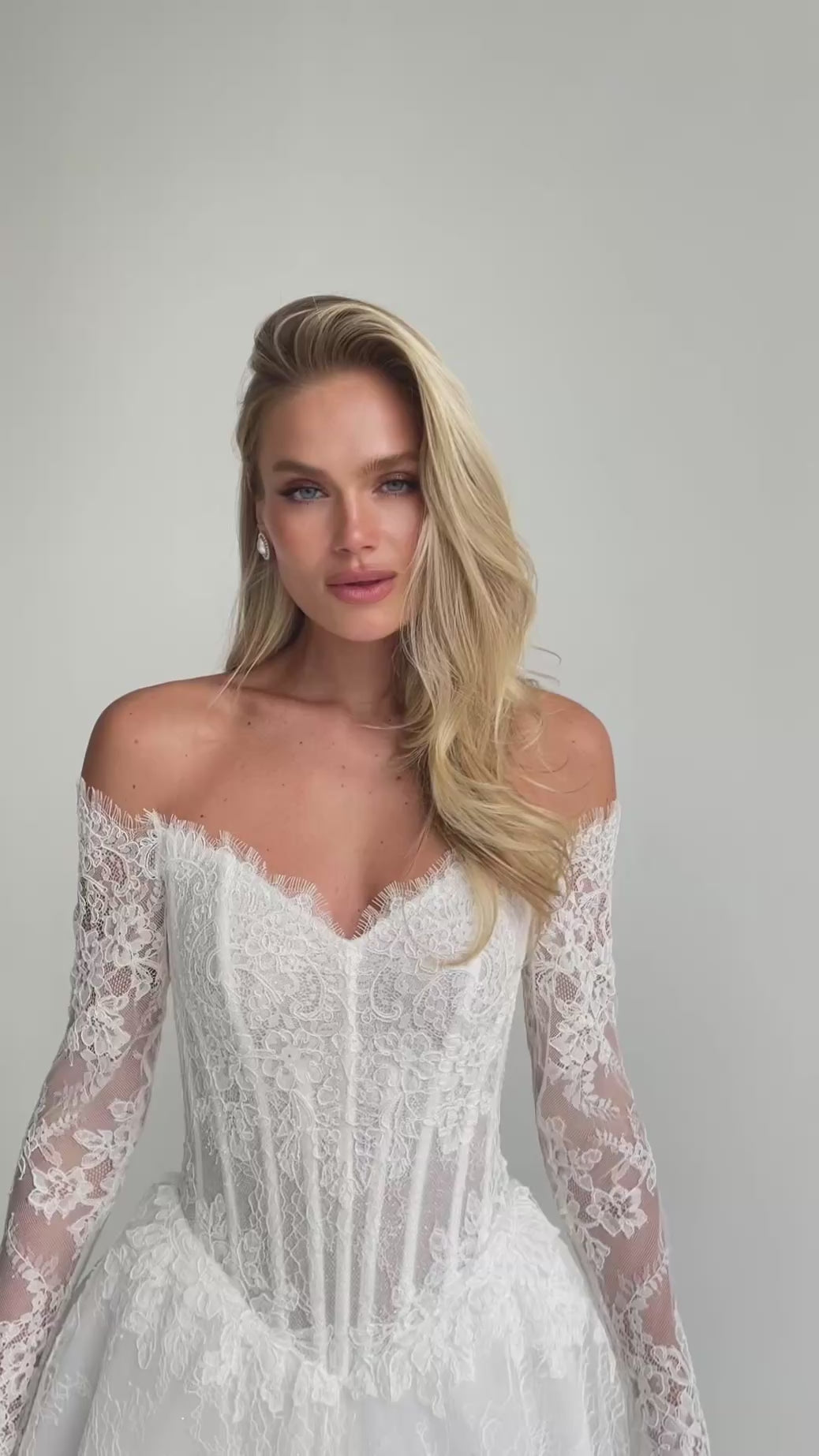 Video: close-up of an off-shoulder sweetheart lace corset with long lace sleeves
