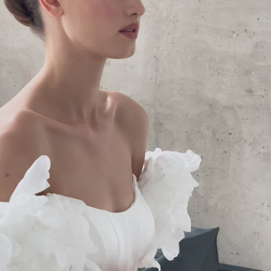A-line corset wedding dress with boat neckline and sleeves