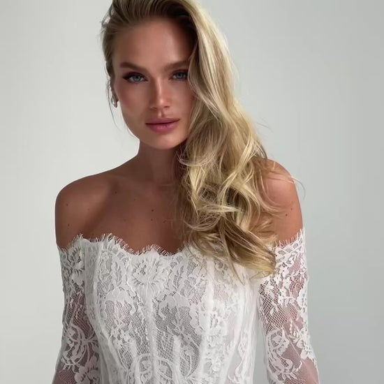 Video: close-up of an off-shoulder lace corset bodice with long lace sleeves