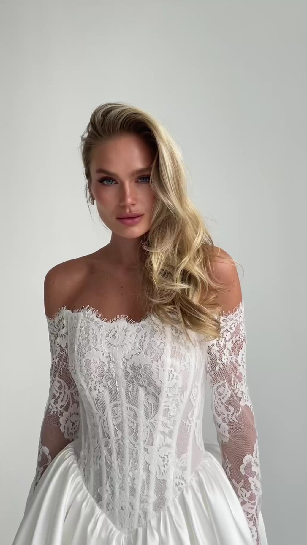 Video: close-up of an off-shoulder lace corset bodice with long lace sleeves