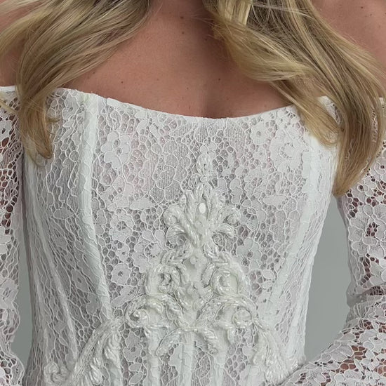 Video: close-up of a beaded lace corset bodice with long lace sleeves