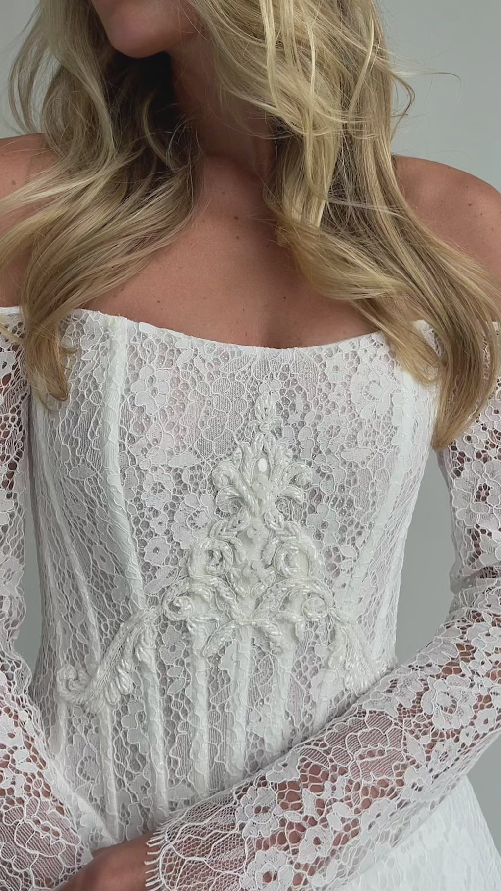Video: close-up of a beaded lace corset bodice with long lace sleeves