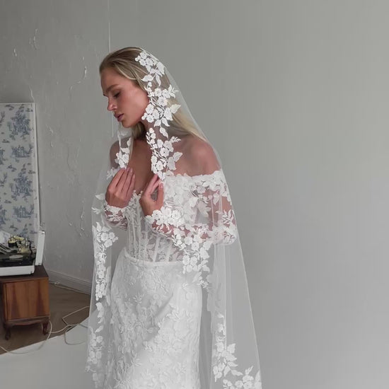Video: bride in a lace-trimmed veil over a lace bodice