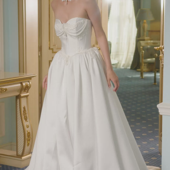 Strapless Mikado princess A-line wedding dress with sweetheart neckline, lace and pearl choker, lace-up closure, and chapel train.