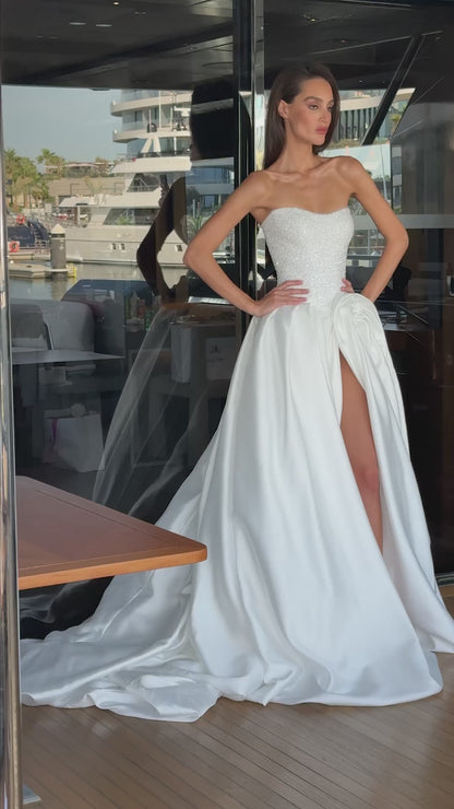 Mikado wedding gown with beaded lace corset, strapless neckline, and high slit.