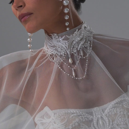Lace sheath wedding dress with strapless corset bodice and sheer cape – video