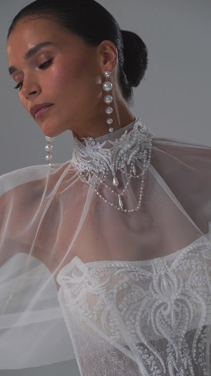 Lace sheath wedding dress with strapless corset bodice and sheer cape – video