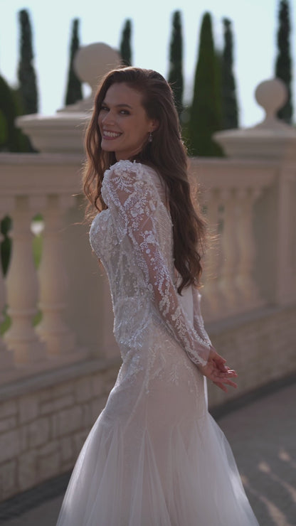 Mermaid wedding dress with long sleeves, bow, and fishtail train