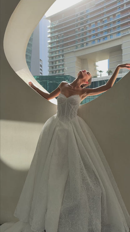 Bride wearing Celeste lace and tulle ball gown with pearl corset and chapel train.