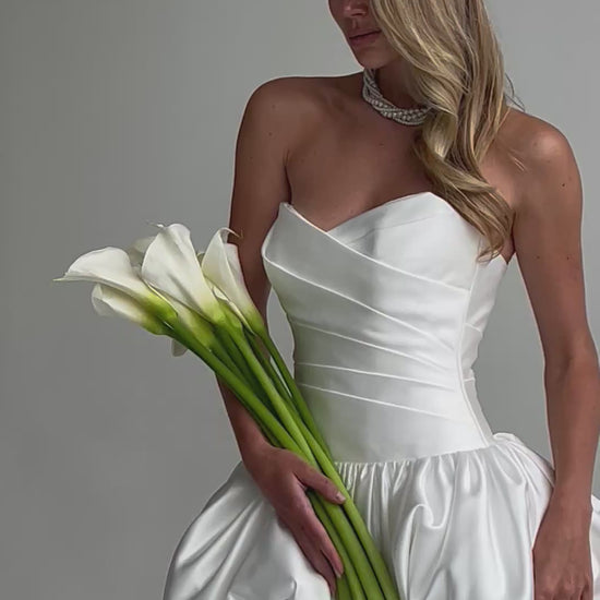 Video: close-up of a ruched satin sweetheart bodice with calla lilies