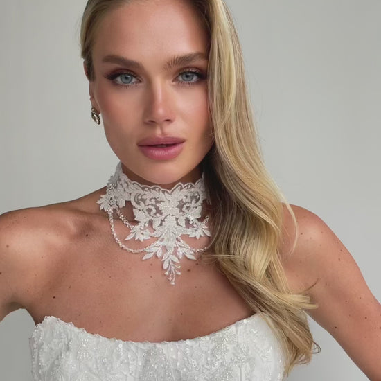 Video: close-up of a beaded lace choker collar over a strapless embroidered bodice