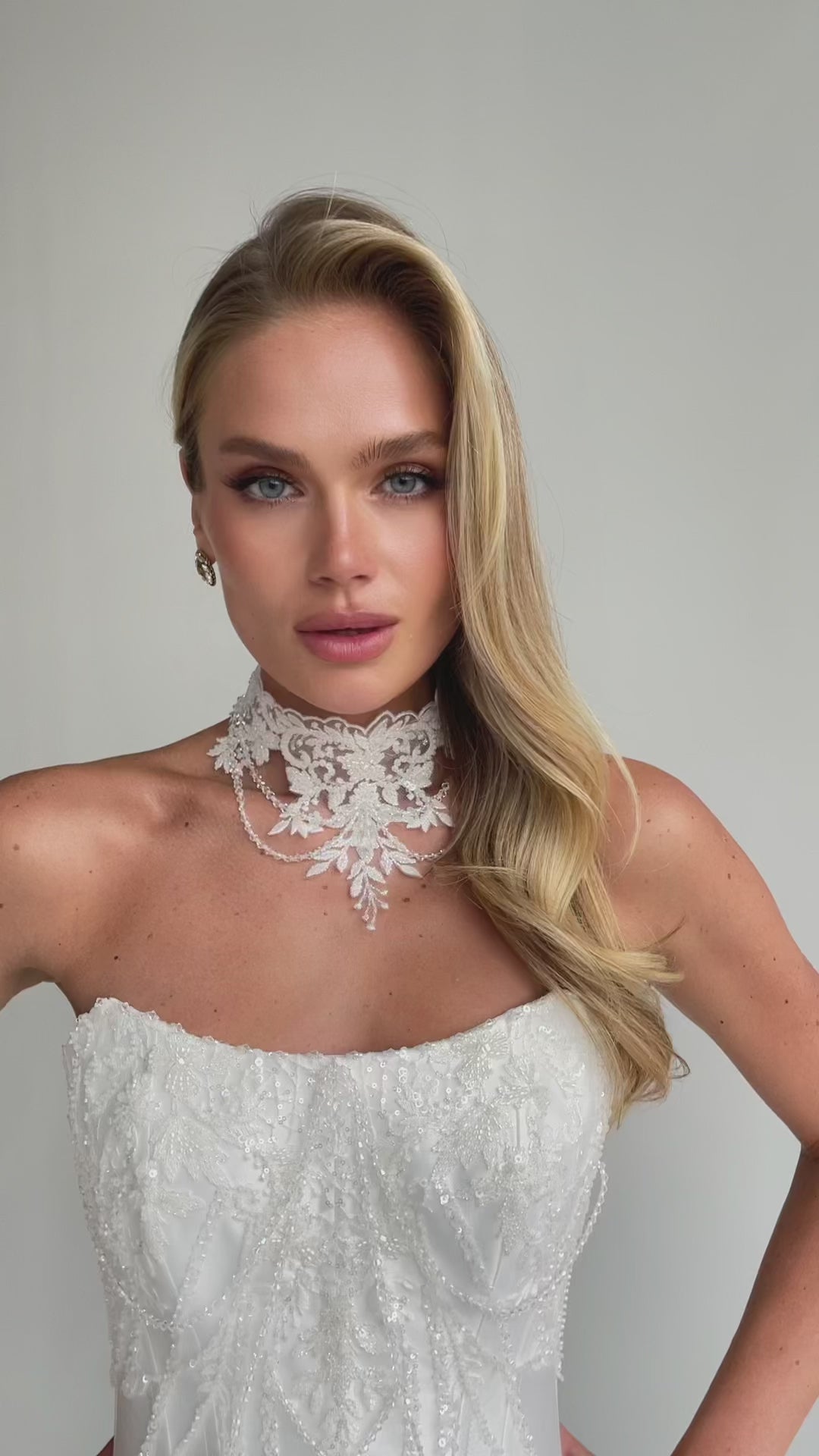 Video: close-up of a beaded lace choker collar over a strapless embroidered bodice