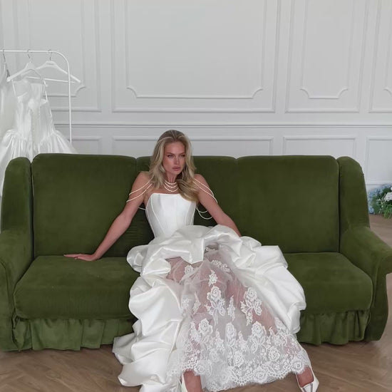 Video: bride on a green velvet sofa in a ruffled satin gown over sheer lace