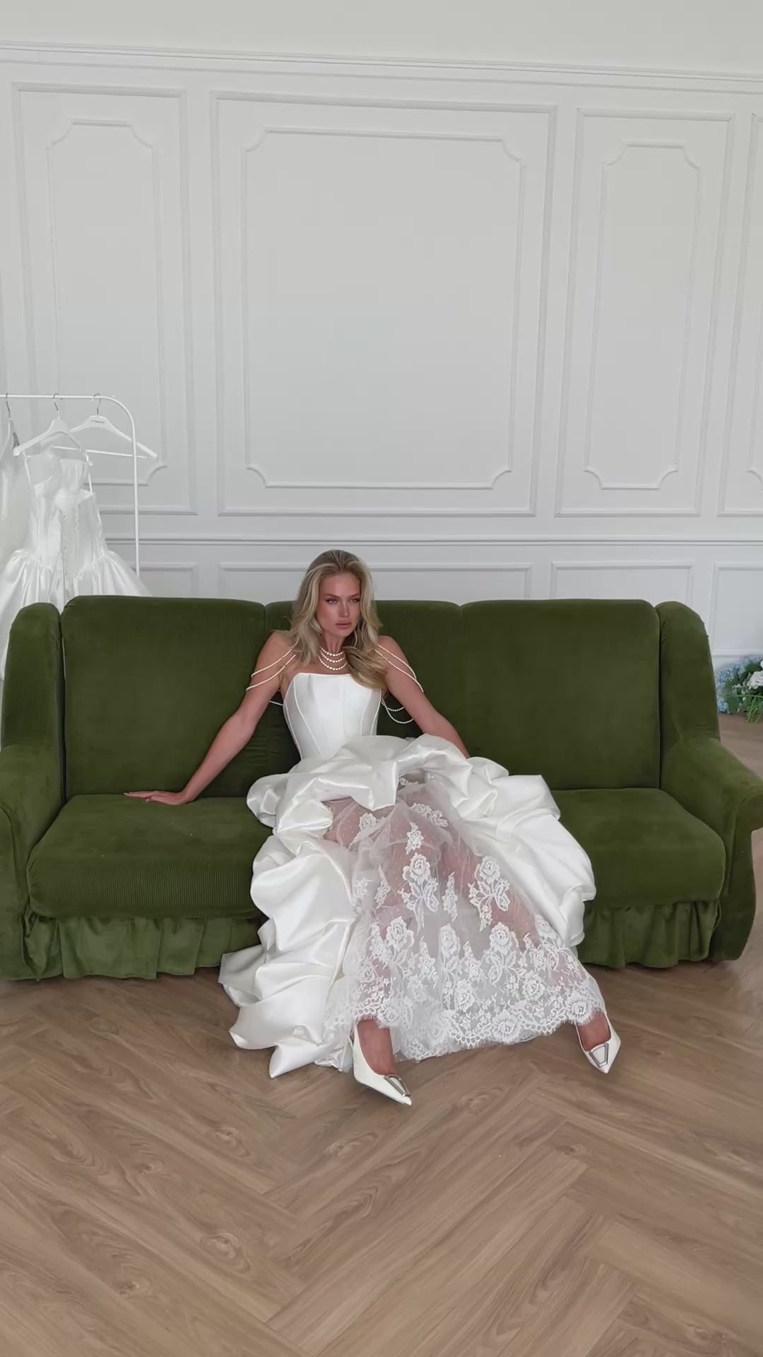 Video: bride on a green velvet sofa in a ruffled satin gown over sheer lace