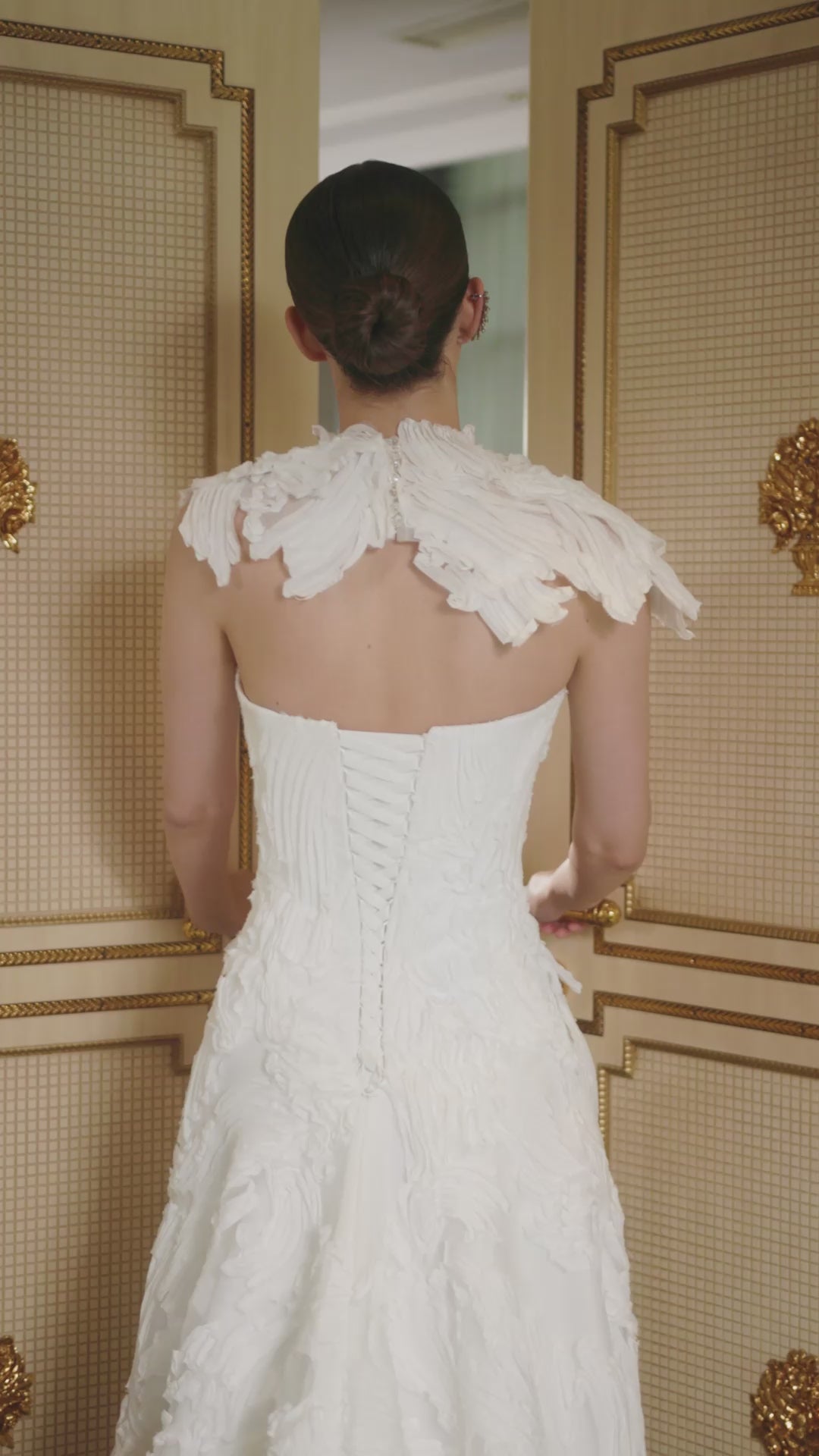 Explore this sculpted lace A-line wedding dress with removable bolero, strapless bodice option, and chapel train. A couture bridal gown offering elegance and versatility.