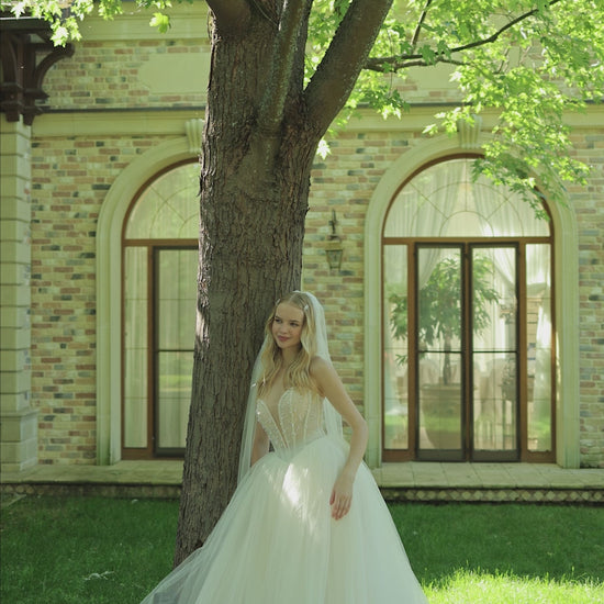 Princess wedding dress with pearl details and chapel train