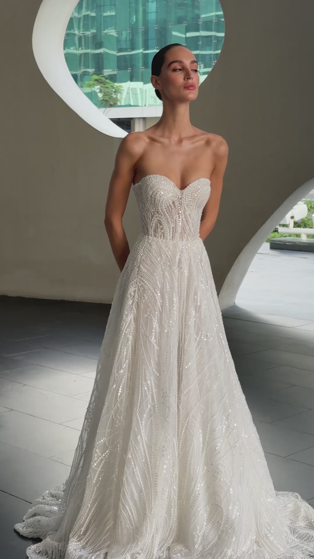 beaded A-line bridal gown with detachable illusion high-neck bolero, sheer long sleeves, button-back, and chapel train.