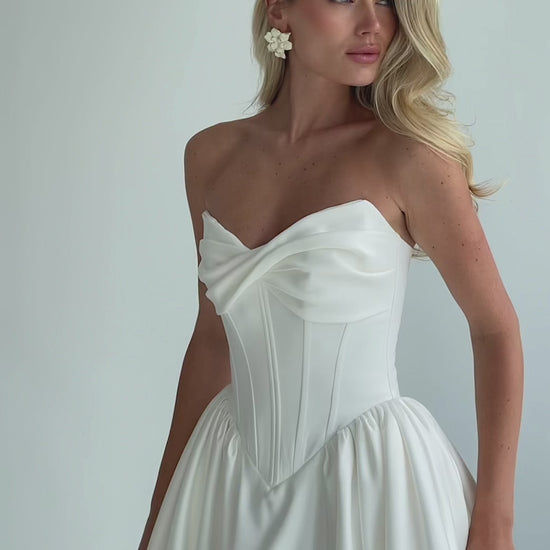 Video: close-up of a strapless draped satin sweetheart bodice
