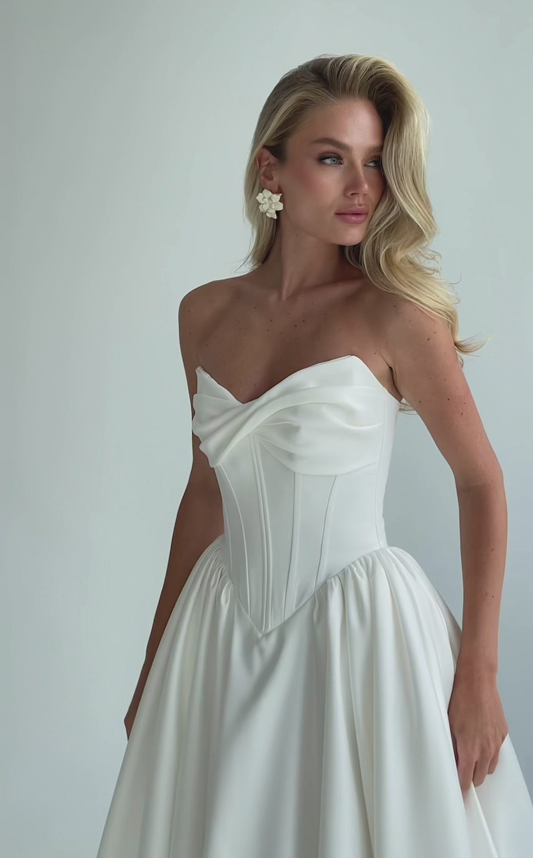 Video: close-up of a strapless draped satin sweetheart bodice