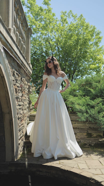 Off-the-shoulder A-line wedding dress with lace-up corset