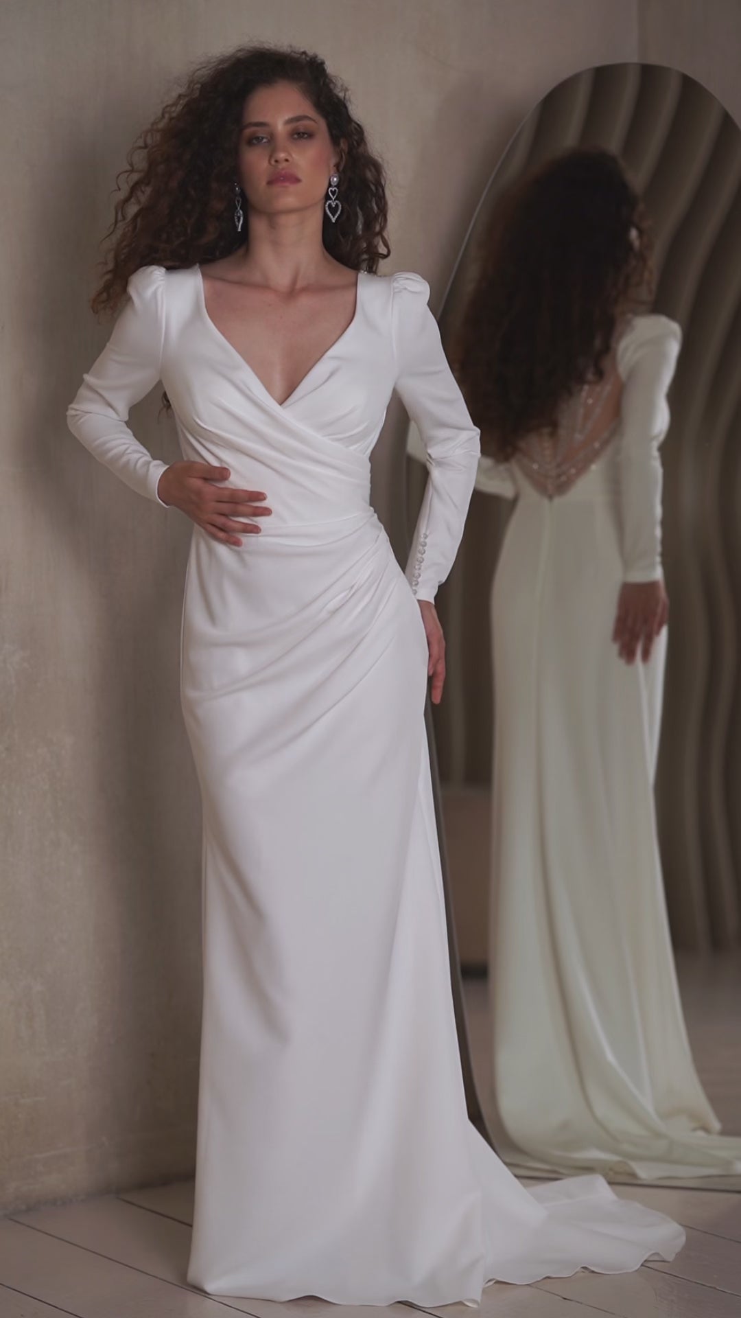Minimalist crepe wedding dress with long sleeves and V-neckline