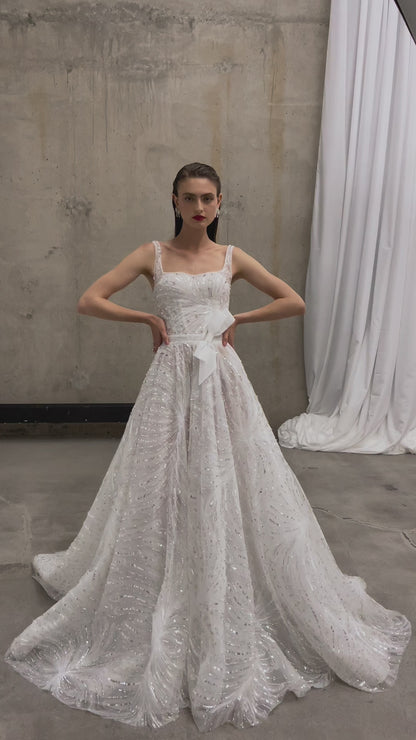 Sleeveless wedding dress with chapel train and sequin lace.