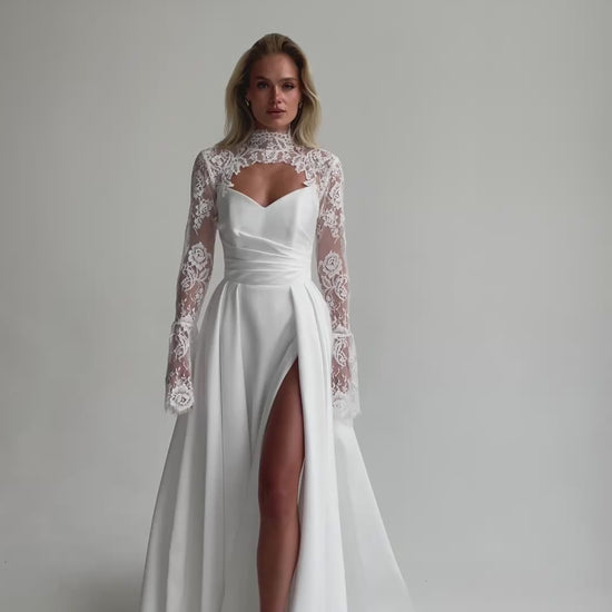 Video: full-length satin wedding dress with a high slit and a lace bolero