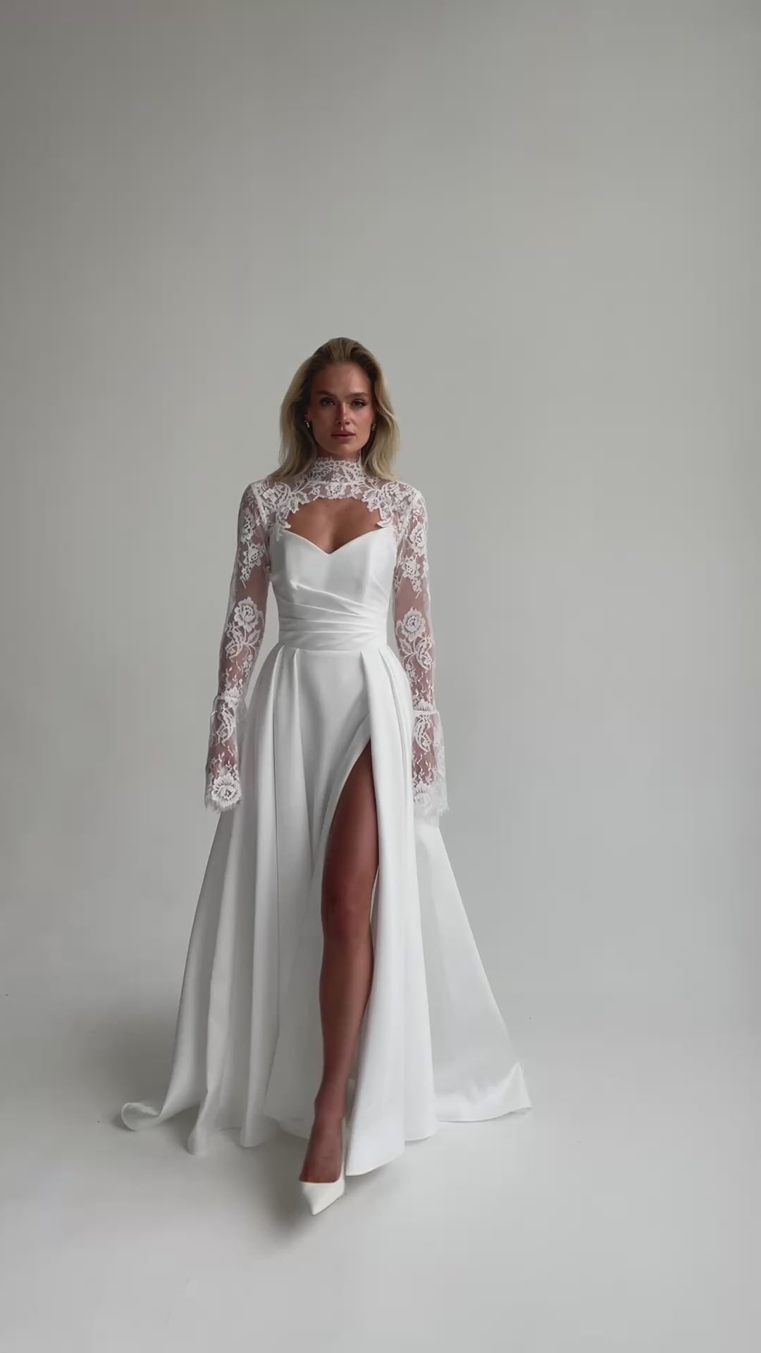 Video: full-length satin wedding dress with a high slit and a lace bolero