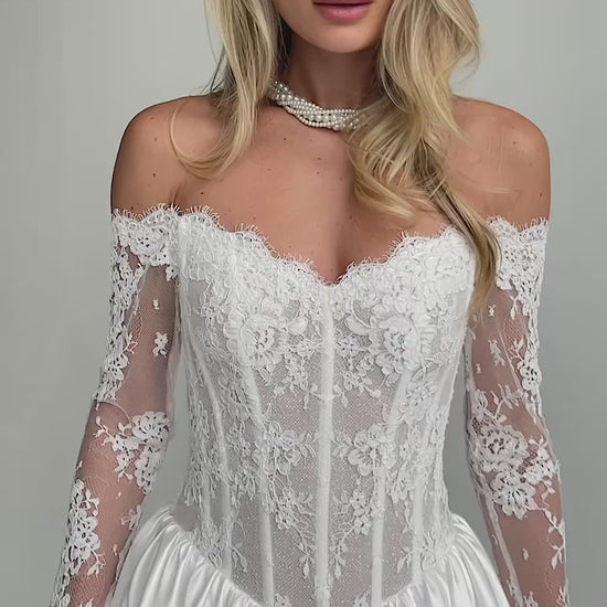 Video: close-up of an off-shoulder lace corset bodice with long lace sleeves