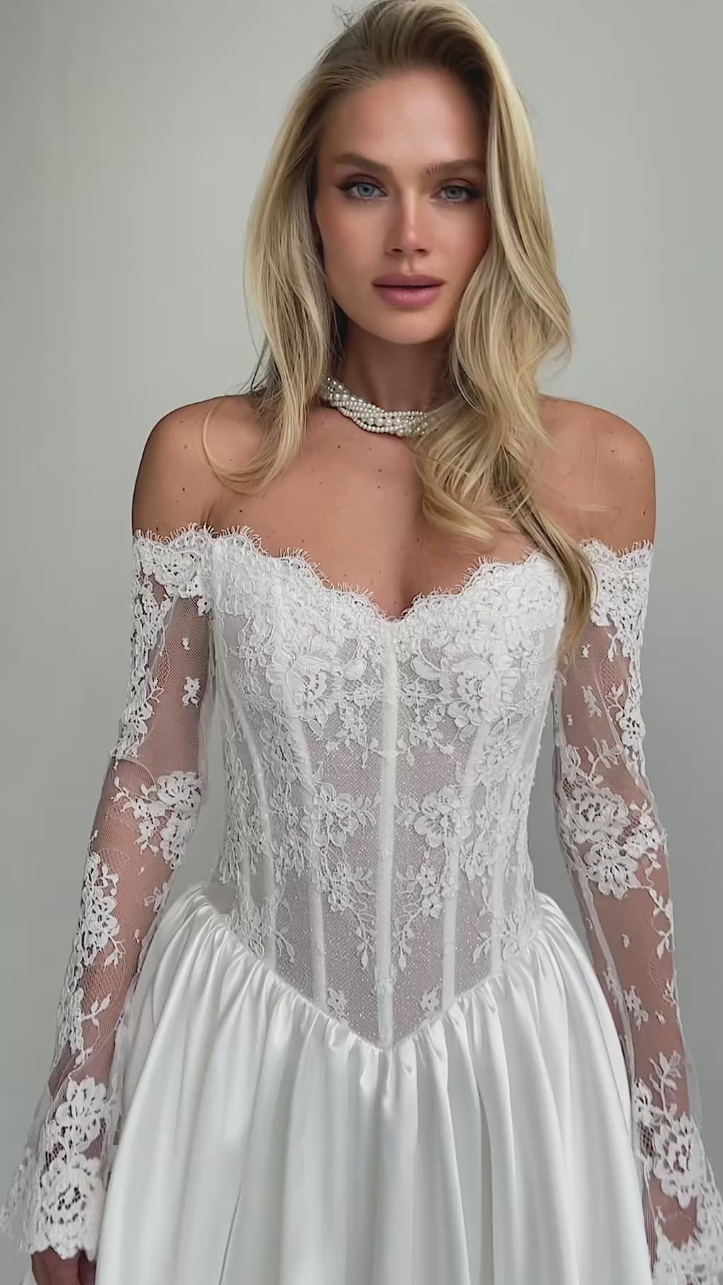 Video: close-up of an off-shoulder lace corset bodice with long lace sleeves