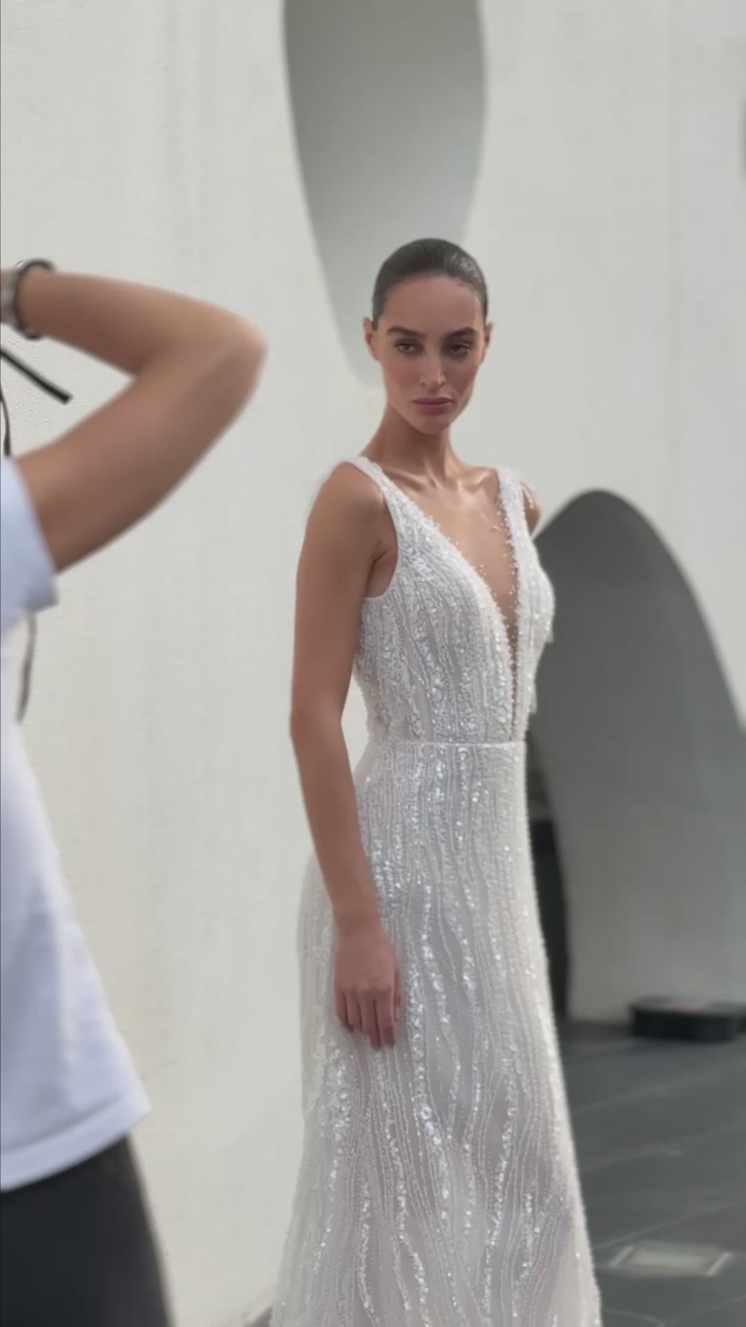 Radiant beaded A-line wedding gown with deep V neckline and open back, featuring a soft flowing tulle train.