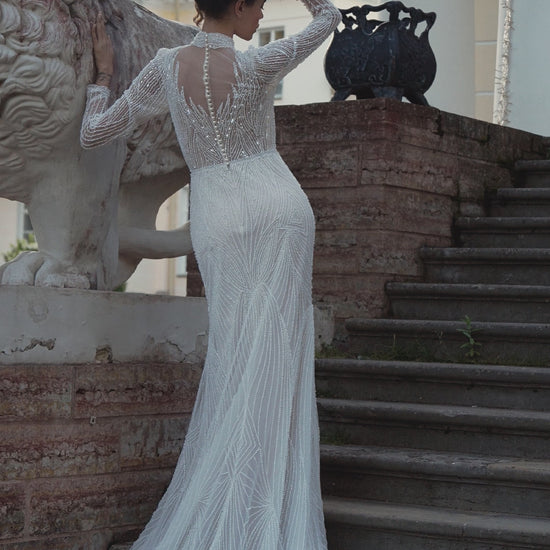 Beaded lace mermaid wedding gown with long sleeves and illusion neckline
