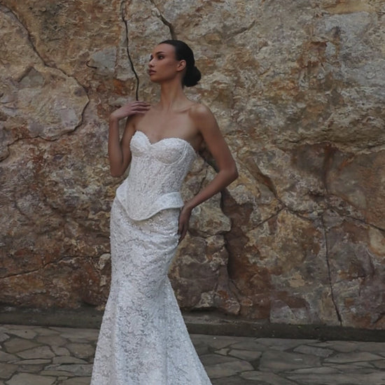 Mermaid wedding dress with sweetheart neckline, sleeveless pearl lace corset, longline bodice, and fishtail court train. Luxurious modern bridal gown.