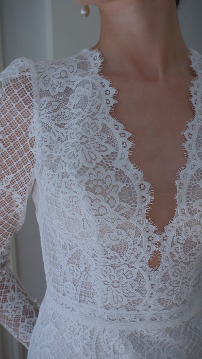 Mermaid wedding dress with lace, long sleeves, and open back