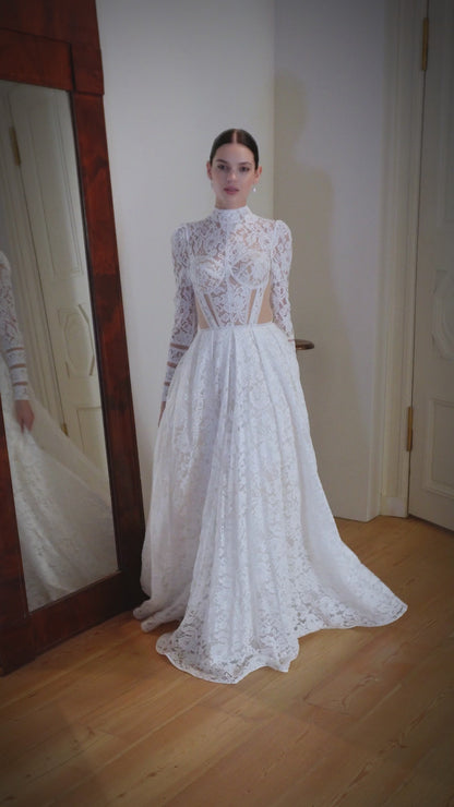 Princess wedding dress with chapel train and long sleeves.