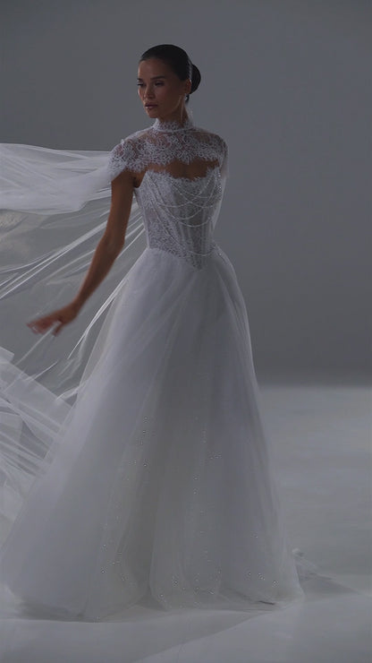 Tulle wedding dress with lace corset, sweetheart neckline and sheer cape – video