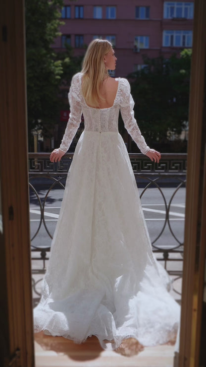 A-line wedding dress with long sleeves and open back.