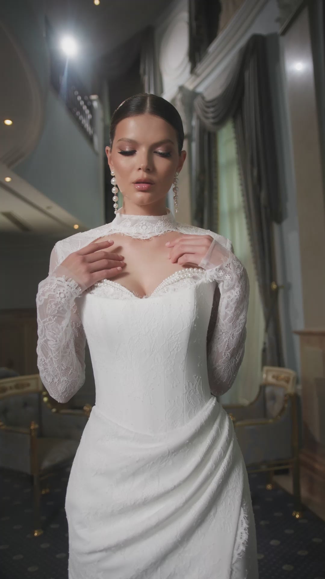 Bride in fitted lace wedding dress with sweetheart neckline, removable long-sleeve lace bolero, thigh-high slit, and chapel train.
