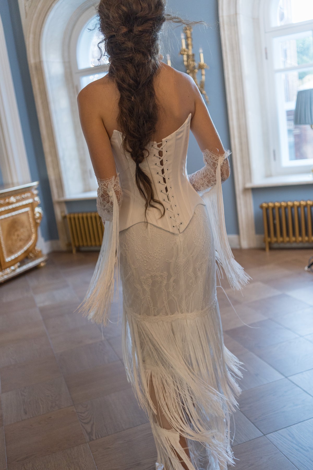 Strapless mikado corset wedding dress – close back view of the corset lacing and fringe skirt
