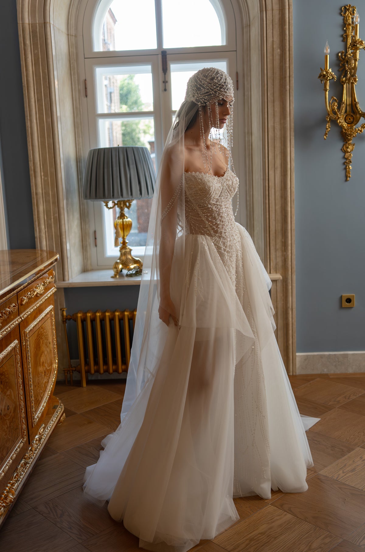 Beaded pearl corset wedding dress with layered tulle skirt – side view of the tulle layers
